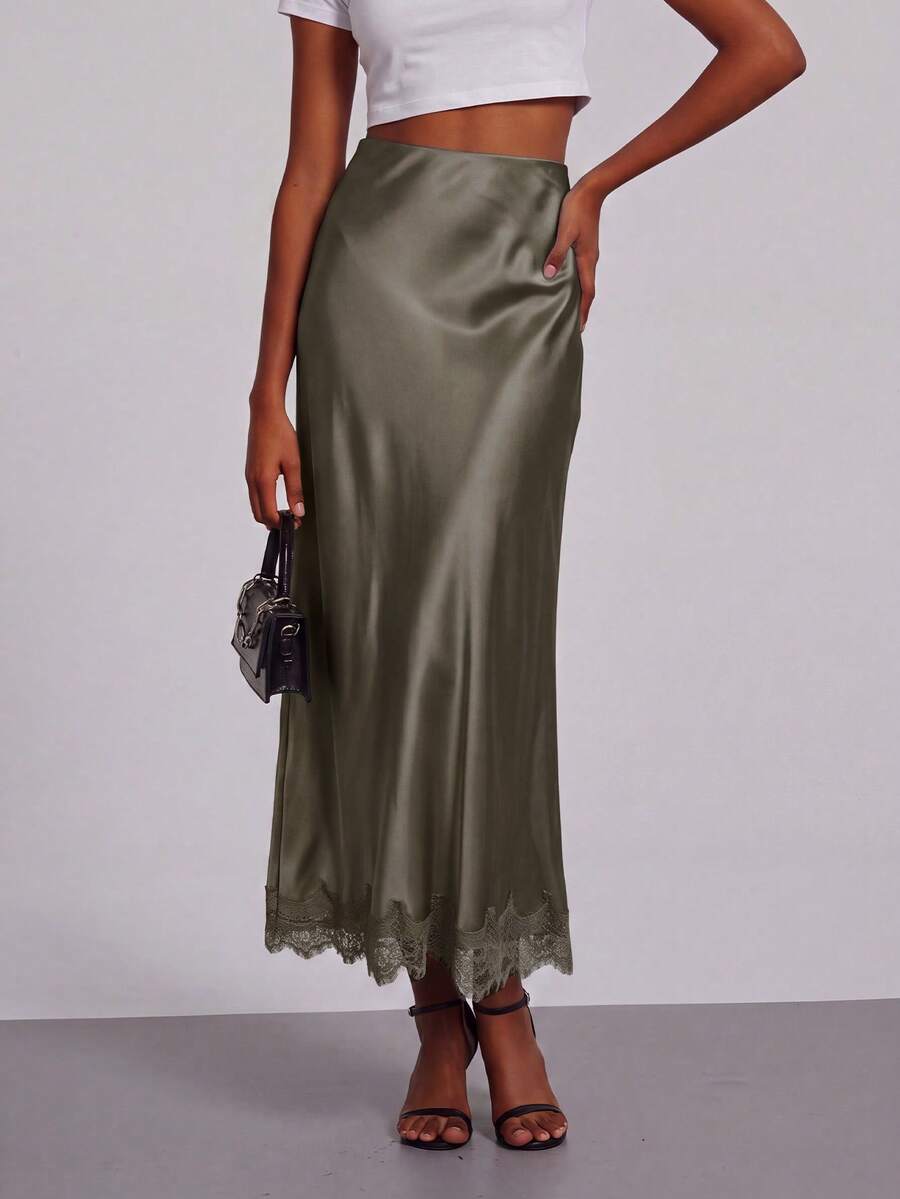 Women's black lace patchwork satin skirt featuring a long bodycon silhouette and natural mid waist design.