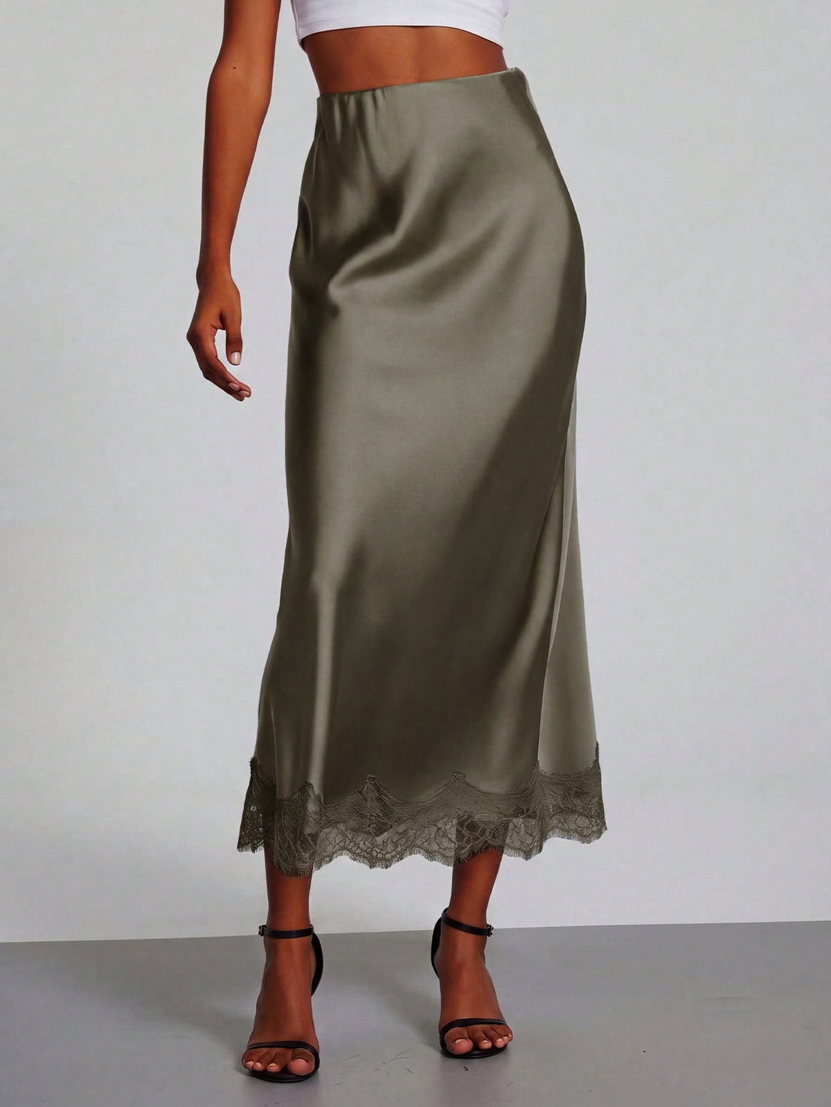 Women's black lace patchwork satin skirt featuring a long bodycon silhouette and natural mid waist design.