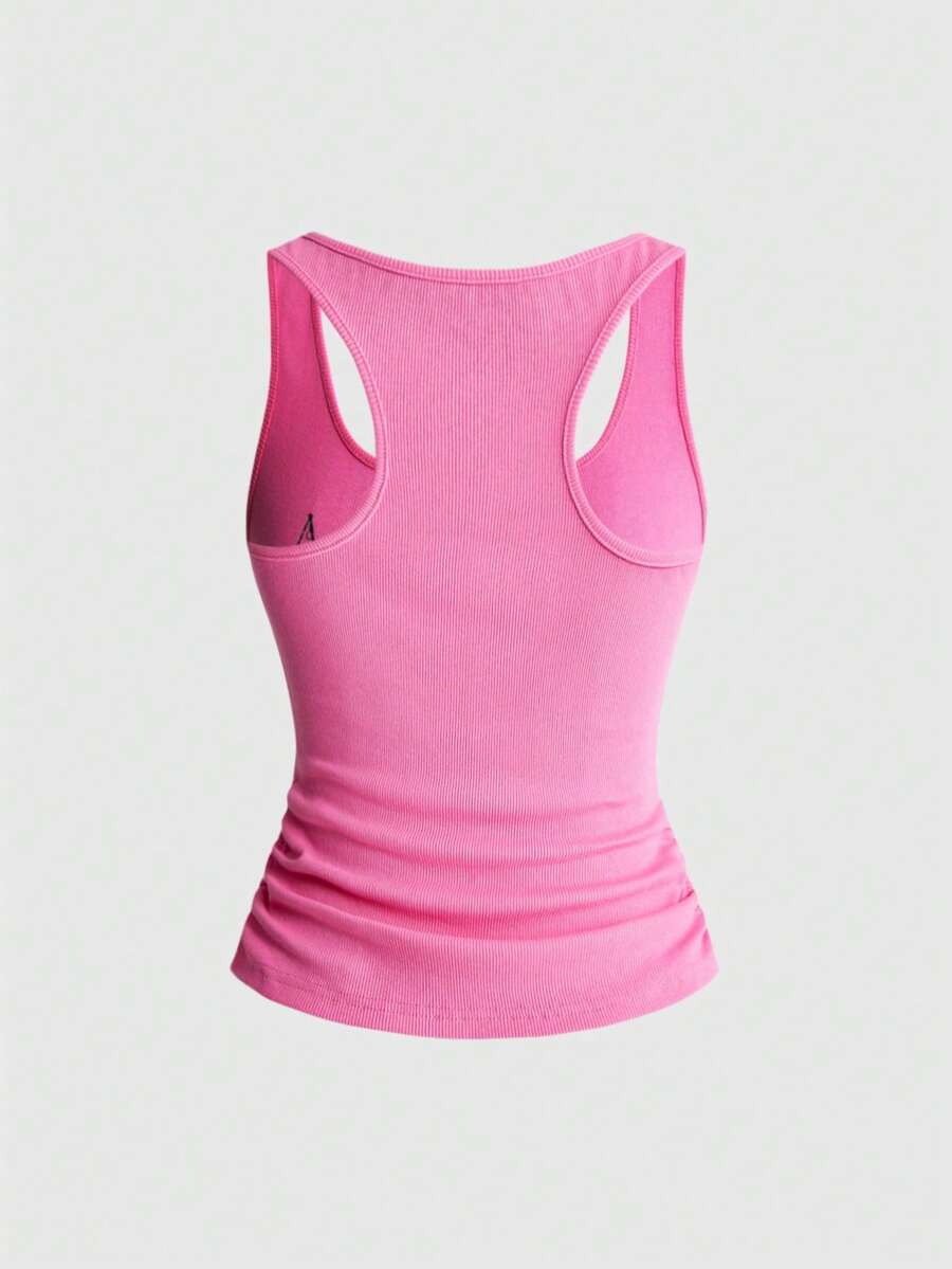 Women's white scoop neck camisole tank top featuring a badge patchwork print, front bow tie detail, cut-out accents, and slim-fit cotton stretch fabric.