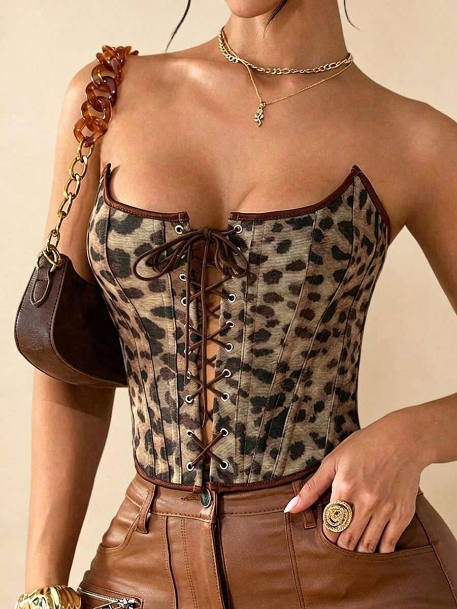 Front view of brown leopard print strapless waist cincher crop top featuring front lace-up detail with metal eyelets and asymmetrical hem for women.