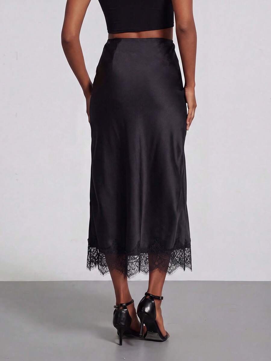 Women's black lace patchwork satin skirt featuring a long bodycon silhouette and natural mid waist design.