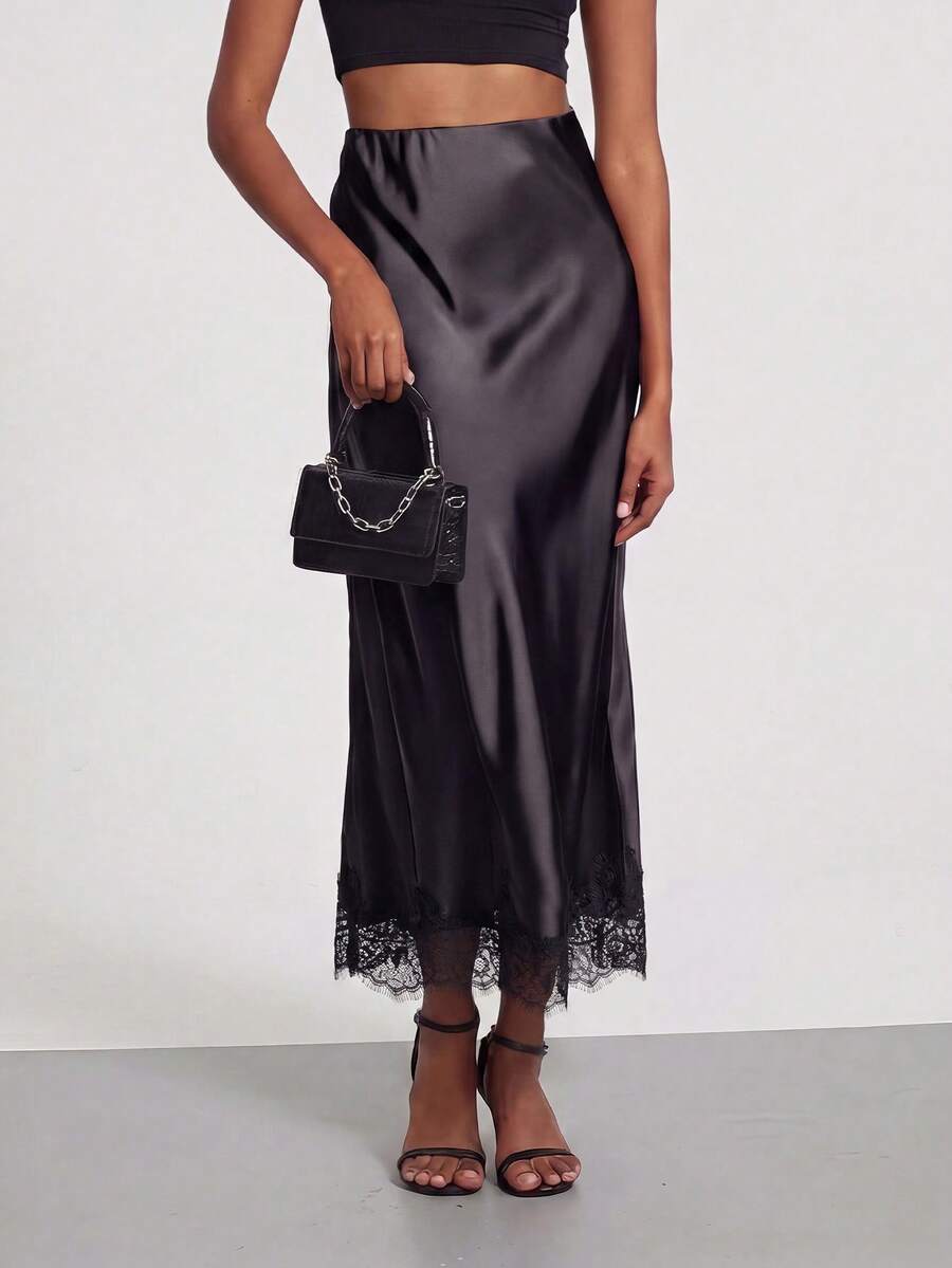Women's black lace patchwork satin skirt featuring a long bodycon silhouette and natural mid waist design.