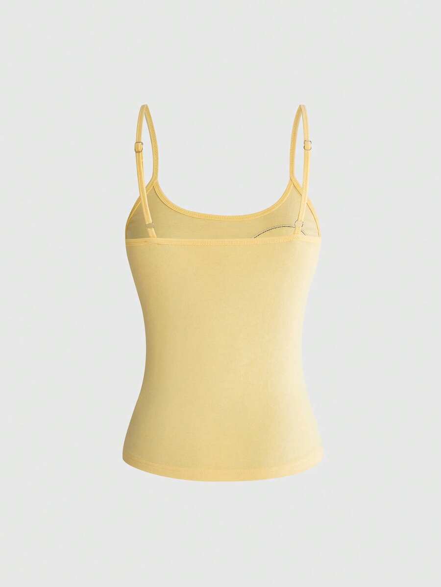 Women's white graphic tank top featuring a cartoon 3D applique patch with a slim fit sleeveless cut.