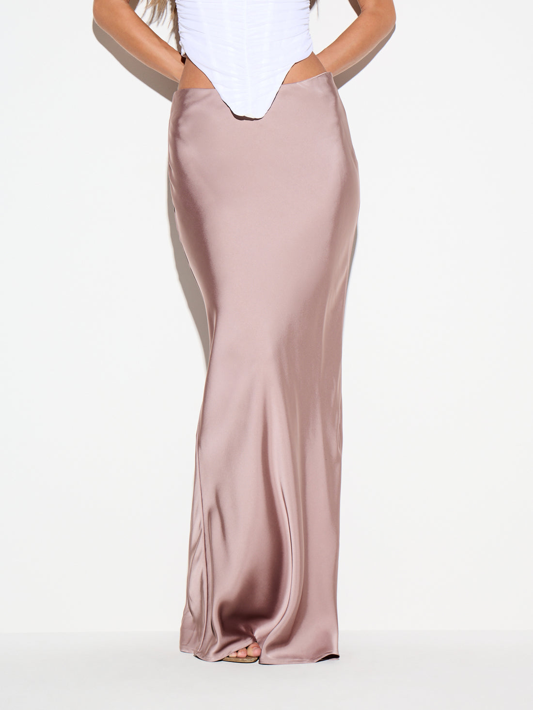 Dusty purple satin maxi skirt for women featuring a low waist V-cut line, sleek mermaid bodycon silhouette, side split, and floor-length hem.
