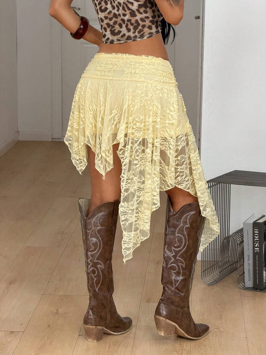 Women's asymmetrical ruffle skort with low waist, hollow out details, and lined body in knitted stretch fabric for beach and summer wear.