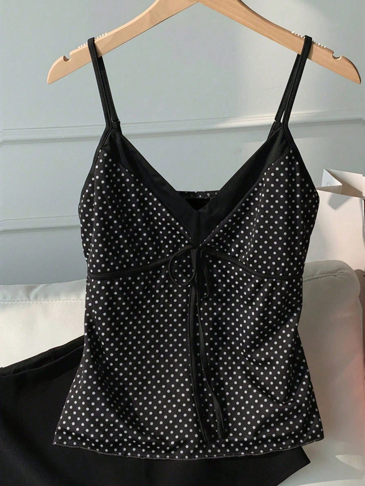 Black and white polka dot tie strap camisole top for women with thin spaghetti straps and slim fit.
