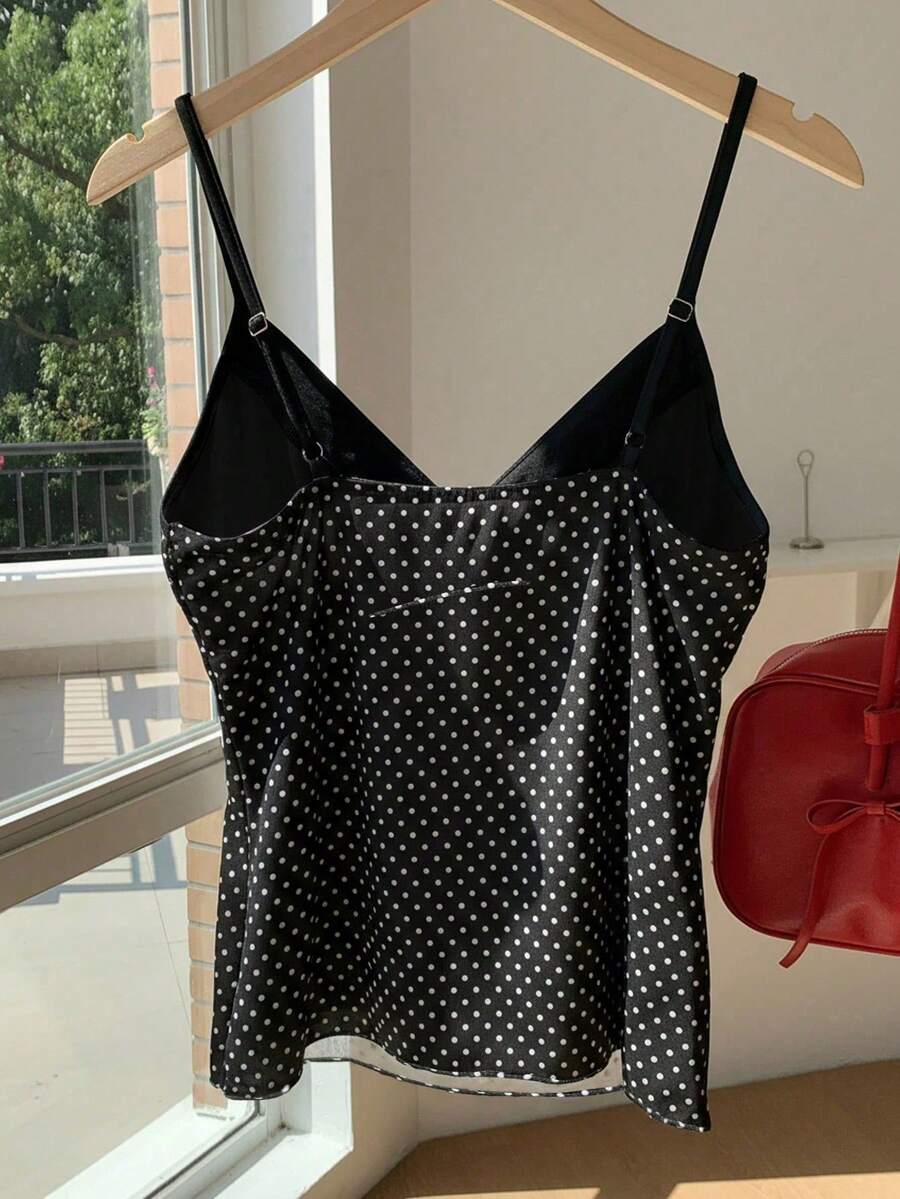 Black and white polka dot tie strap camisole top for women with thin spaghetti straps and slim fit.