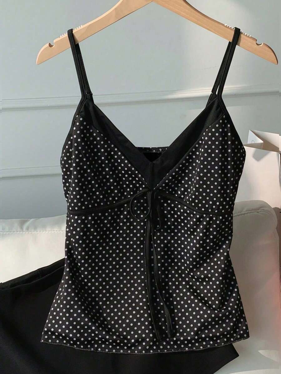 Black and white polka dot tie strap camisole top for women with thin spaghetti straps and slim fit.