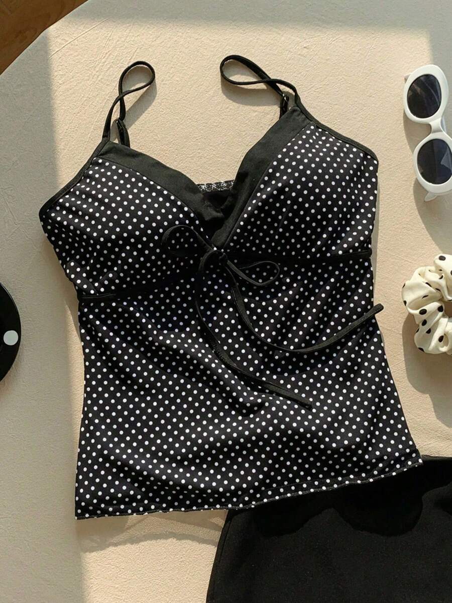 Black and white polka dot tie strap camisole top for women with thin spaghetti straps and slim fit.