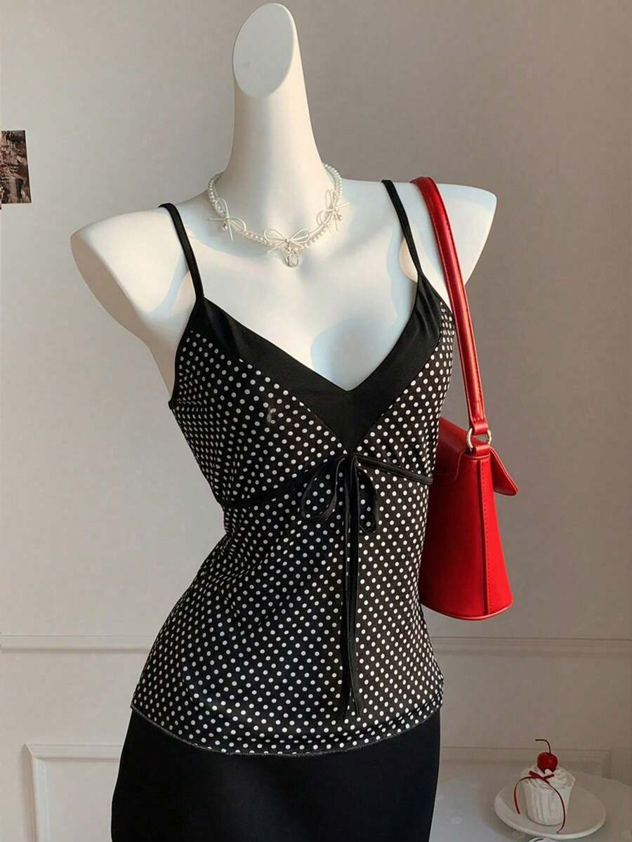 Black and white polka dot tie strap camisole top for women with thin spaghetti straps and slim fit.