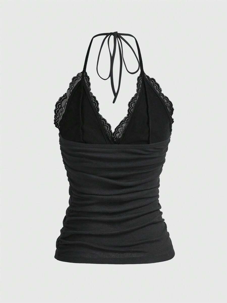 A women's black backless halter top featuring contrast lace trim, ruched front detail, and slim fit soft knitted fabric.