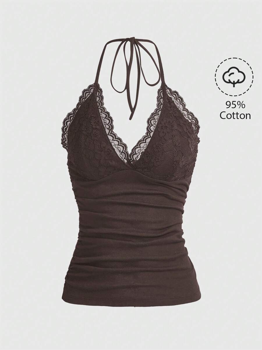 A women's black backless halter top featuring contrast lace trim, ruched front detail, and slim fit soft knitted fabric.