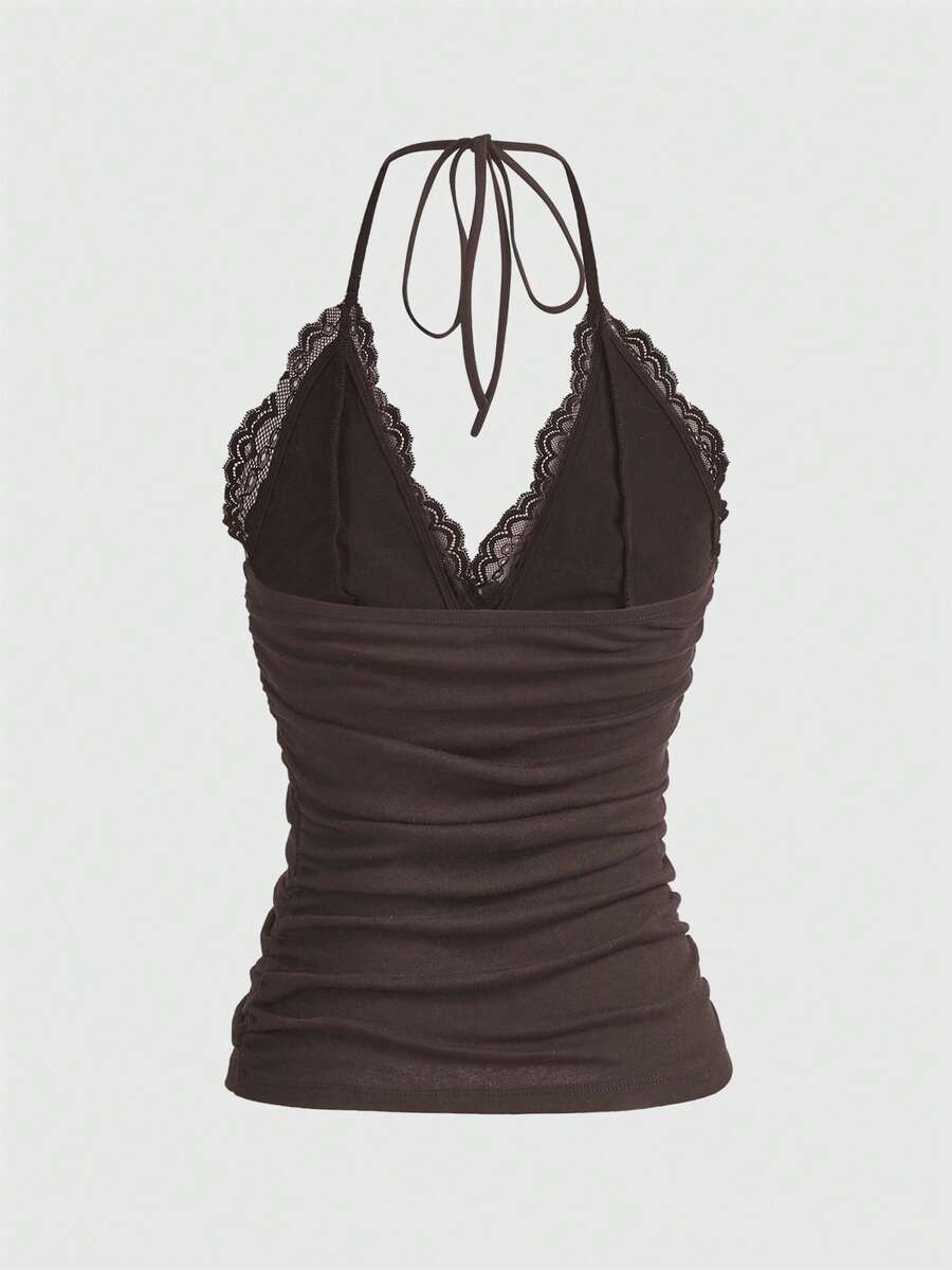 A women's black backless halter top featuring contrast lace trim, ruched front detail, and slim fit soft knitted fabric.
