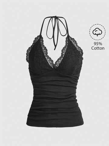 A women's black backless halter top featuring contrast lace trim, ruched front detail, and slim fit soft knitted fabric.