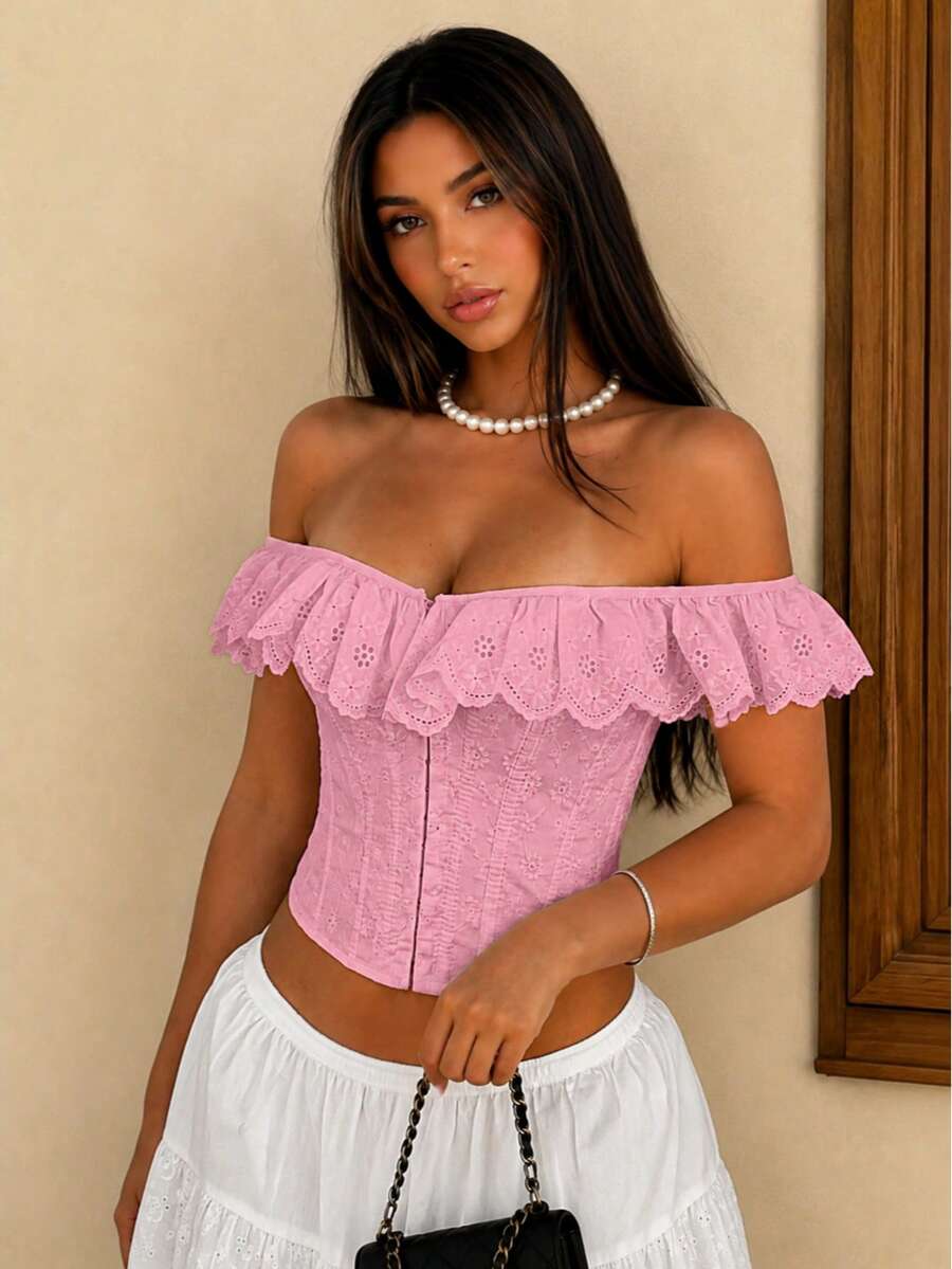 Women’s white corset top with embroidered ruffle trim, off-shoulder neckline, lace-up details, front hook closure, and sleeveless crop fit.