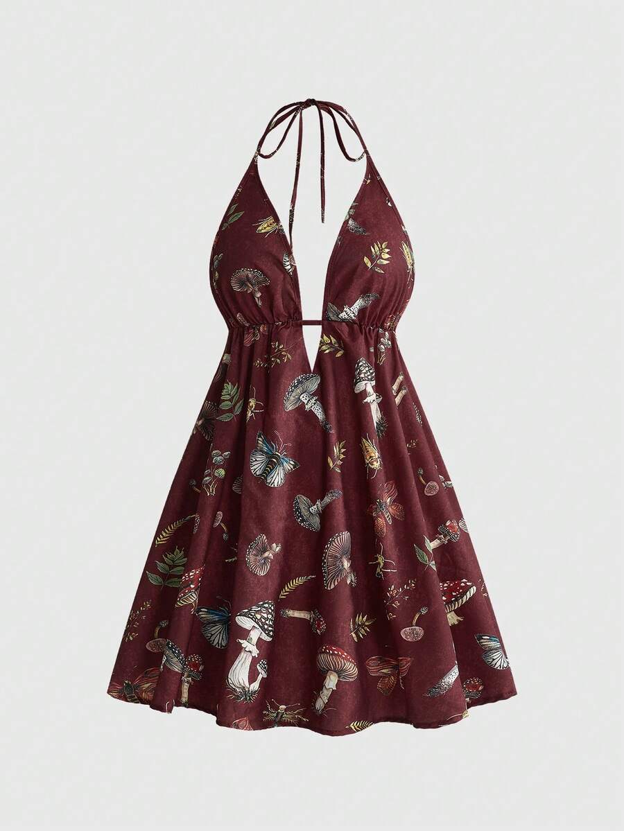 Black fairycore halter backless mini dress with mushroom, moth, and plant print featuring a high waist and flared hem.