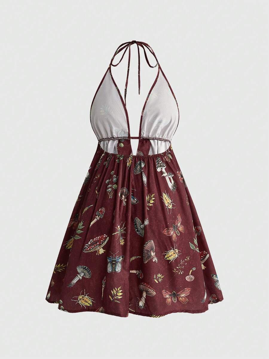 Black fairycore halter backless mini dress with mushroom, moth, and plant print featuring a high waist and flared hem.