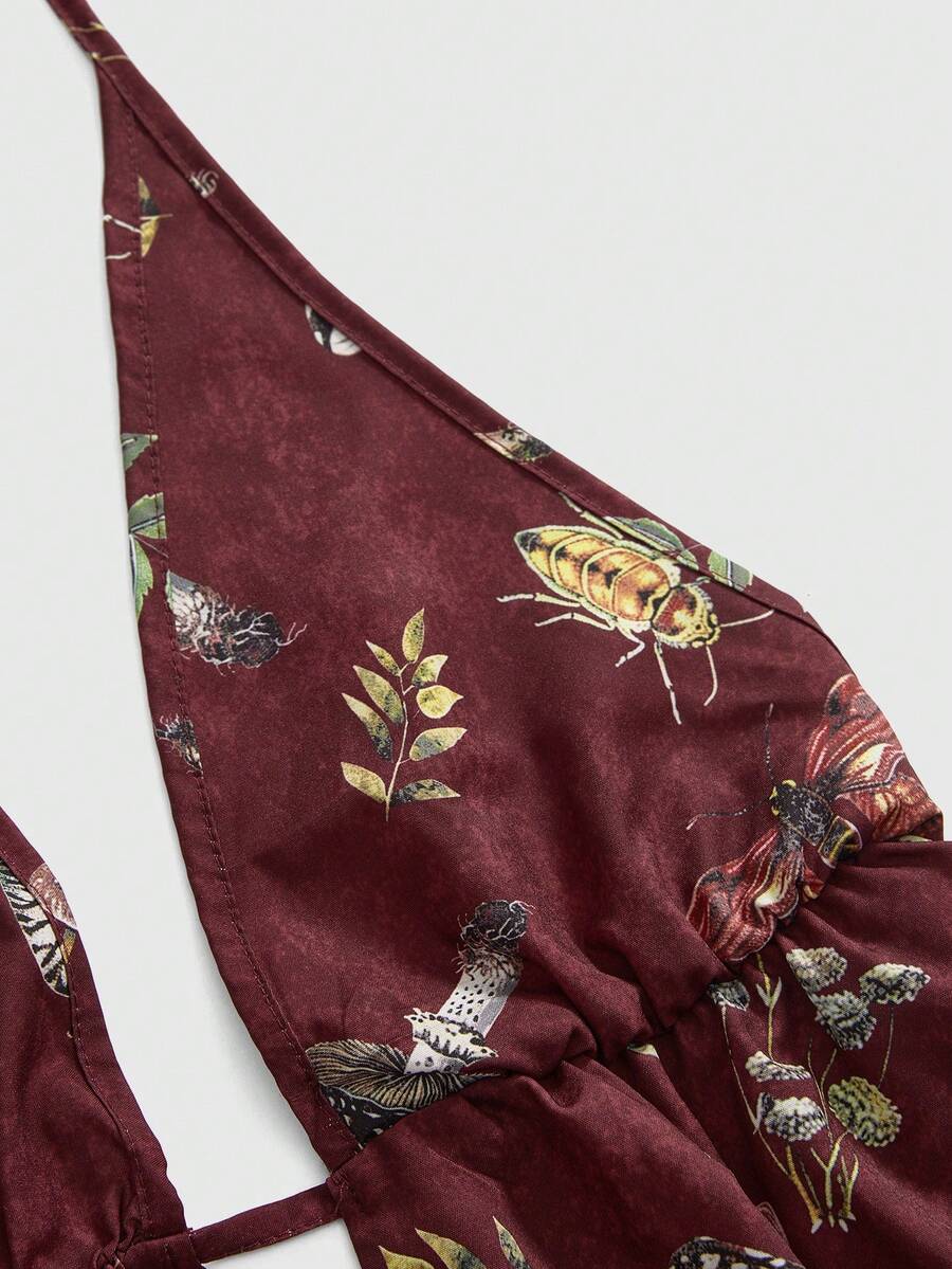 Black fairycore halter backless mini dress with mushroom, moth, and plant print featuring a high waist and flared hem.