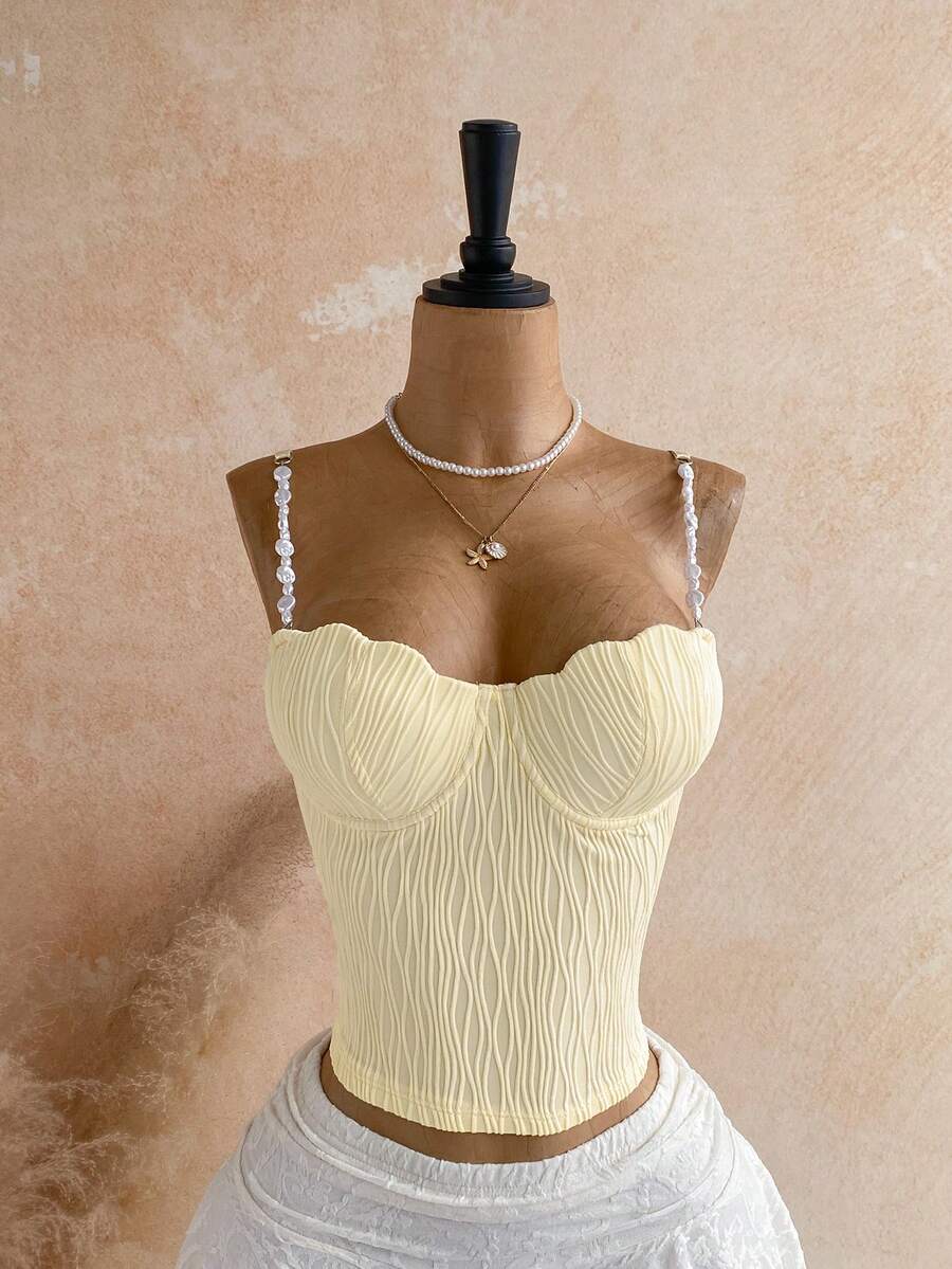 Women's black molded cup camisole top with scallop detailing and spaghetti straps.
