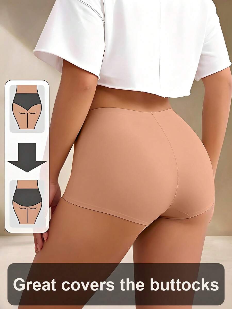 Women's black high stretch shapewear shorts with a mid waist fit and semi-sheer fabric.