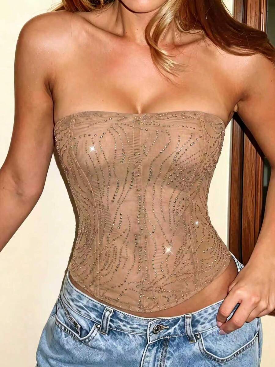 Black strapless corset tube top with sparkling rhinestone decor, boned silhouette, and lace-up tie back.