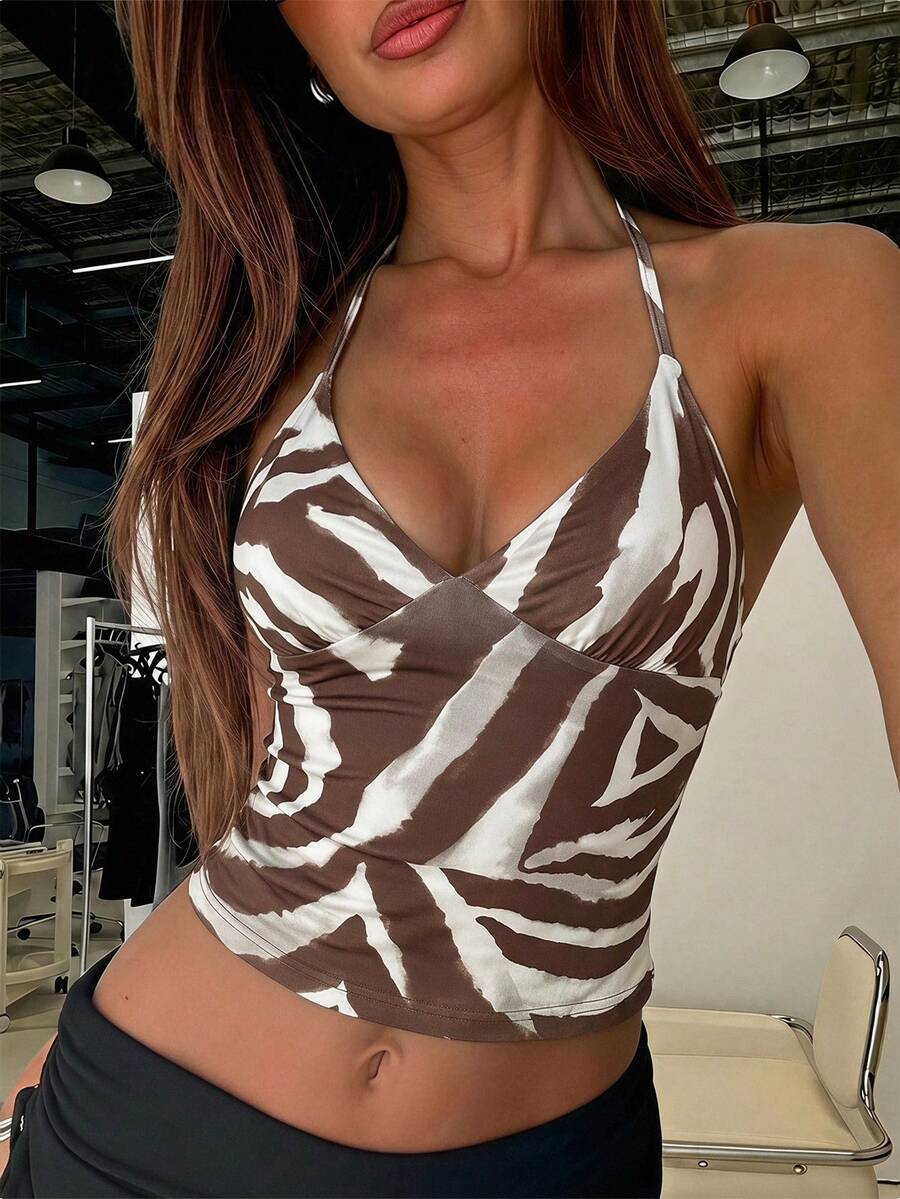 Women's black faux leather backless cami top with spaghetti straps and lace-up shirred sides.