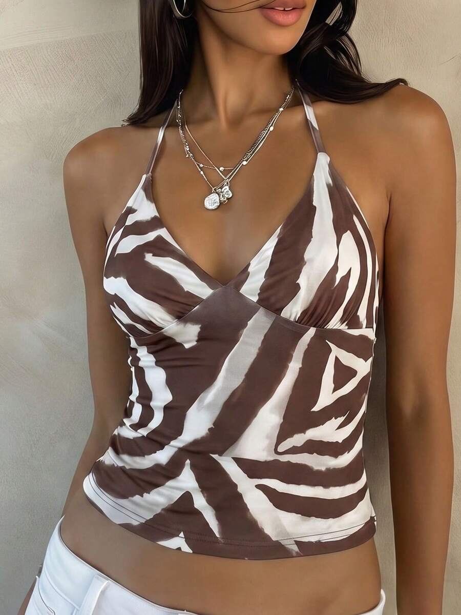 Women's black faux leather backless cami top with spaghetti straps and lace-up shirred sides.