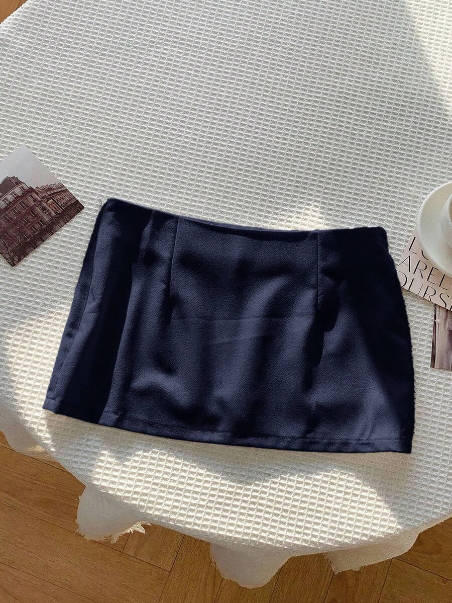 Women's white 100% cotton low waist mini skirt featuring a tropical print and zipper detail.