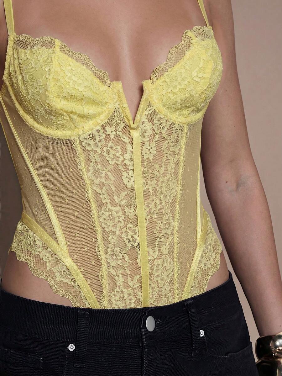 Women's slim fit contrast lace cami bodysuit featuring thin spaghetti straps and asymmetrical detailing.