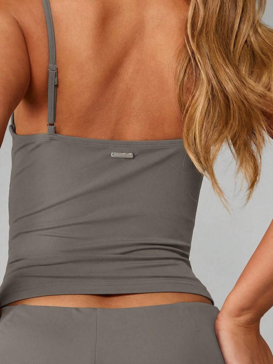 Women’s plain backless cami top with spaghetti straps and a slim fit, designed in high-stretch knitted fabric for casual beach and vacation wear.