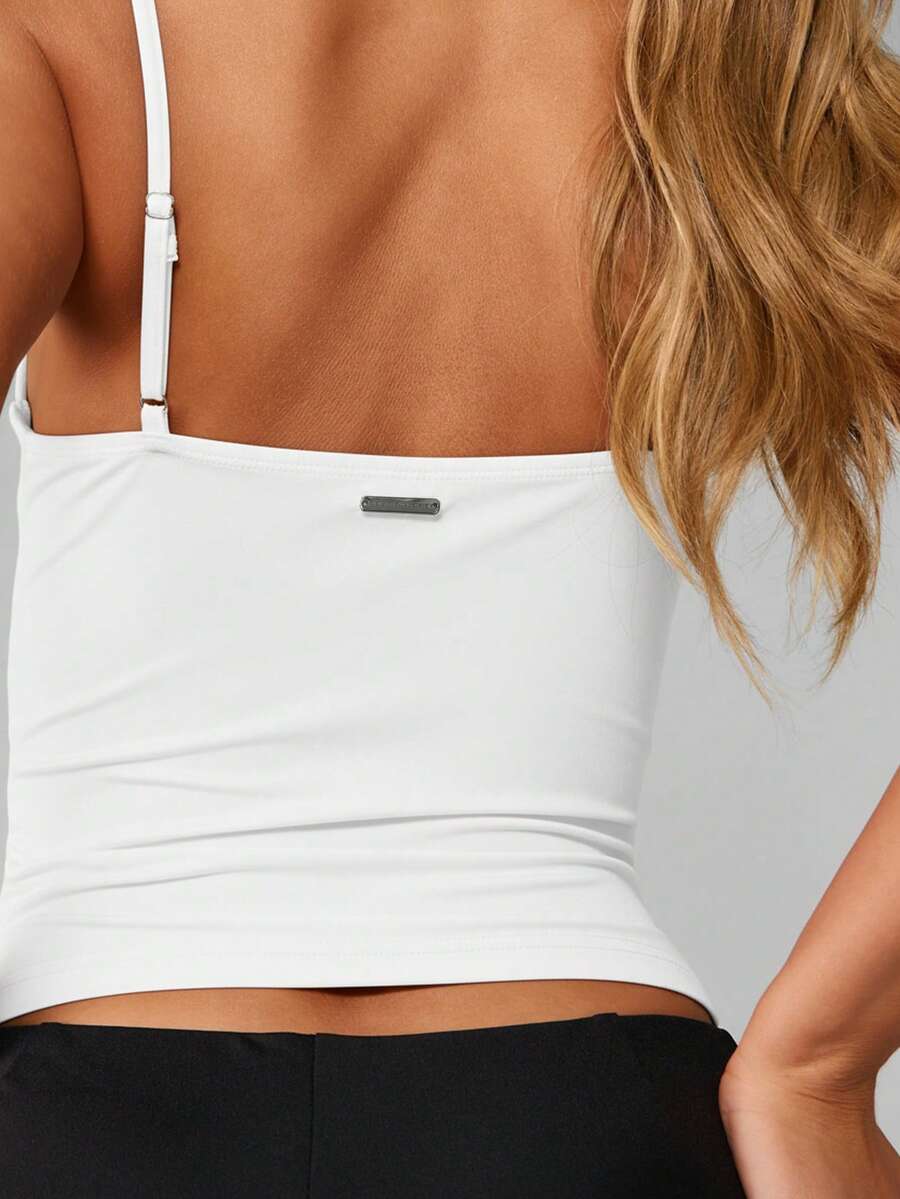 Women’s plain backless cami top with spaghetti straps and a slim fit, designed in high-stretch knitted fabric for casual beach and vacation wear.