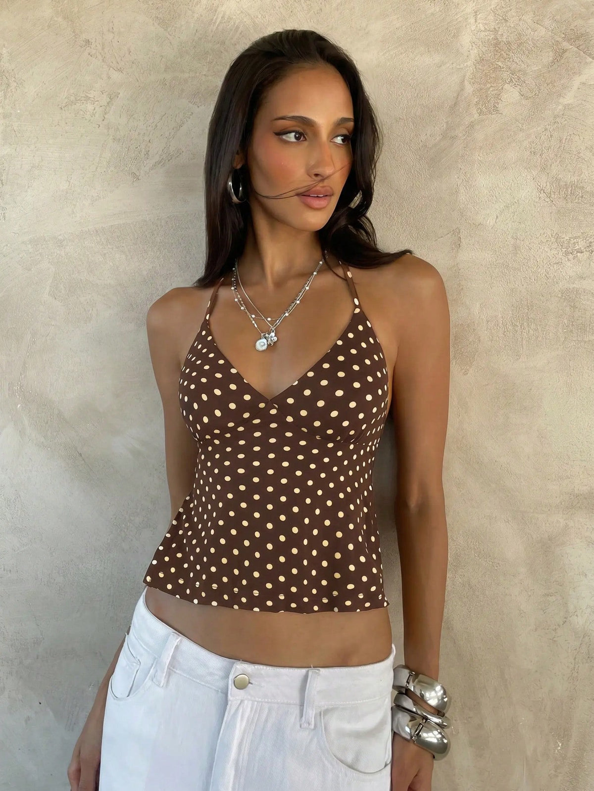 Women's black faux leather backless cami top with spaghetti straps and lace-up shirred sides.