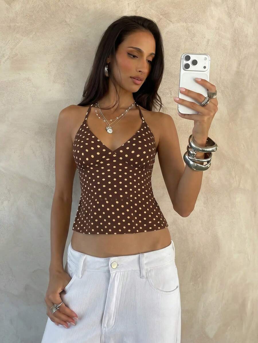 Women's black faux leather backless cami top with spaghetti straps and lace-up shirred sides.