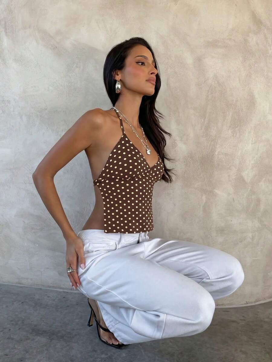 Women's black faux leather backless cami top with spaghetti straps and lace-up shirred sides.