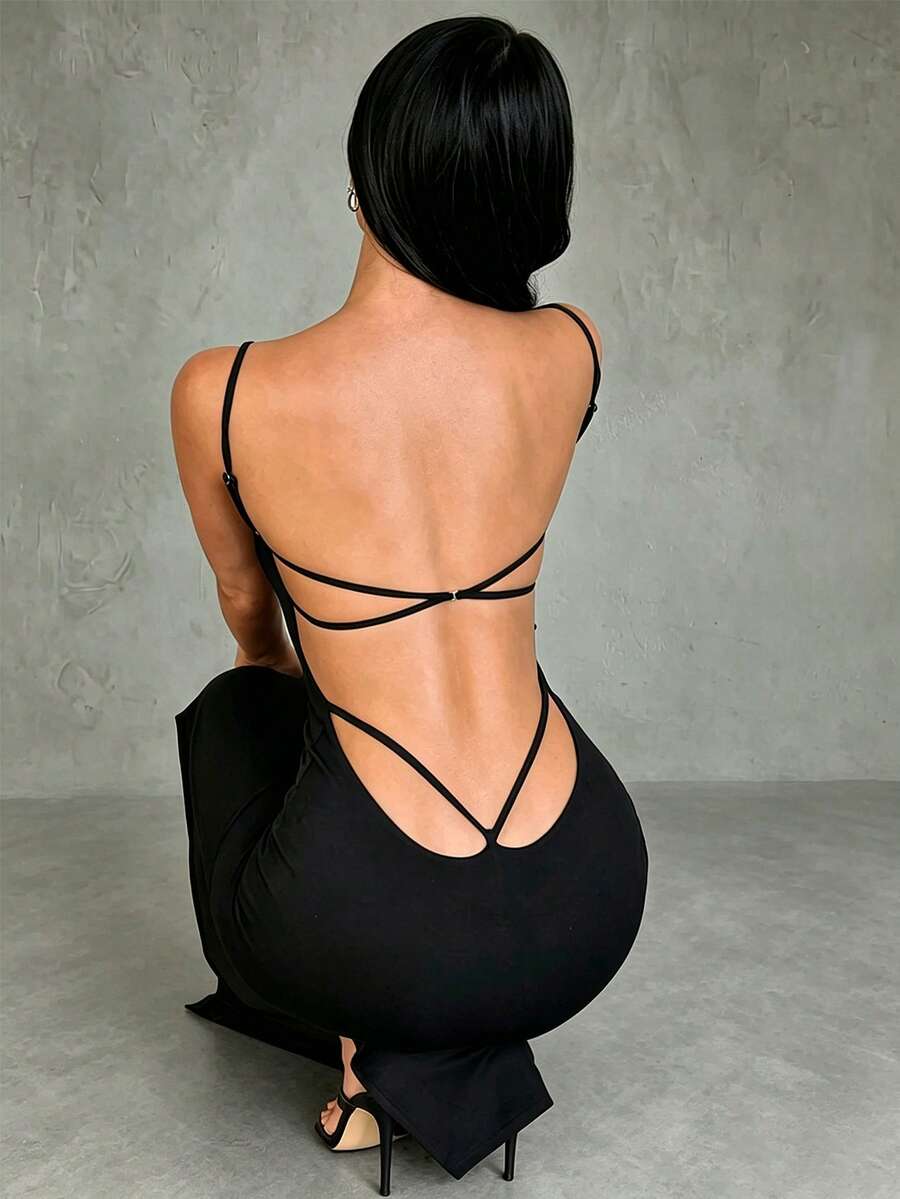 Black backless long cami dress for women featuring criss-cross straps, sleeveless design, and side slit.