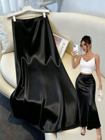Women's elegant black A-line long skirt featuring a plain woven fabric, regular fit, natural mid-waist style, and flared hem design suitable for formal and evening wear.