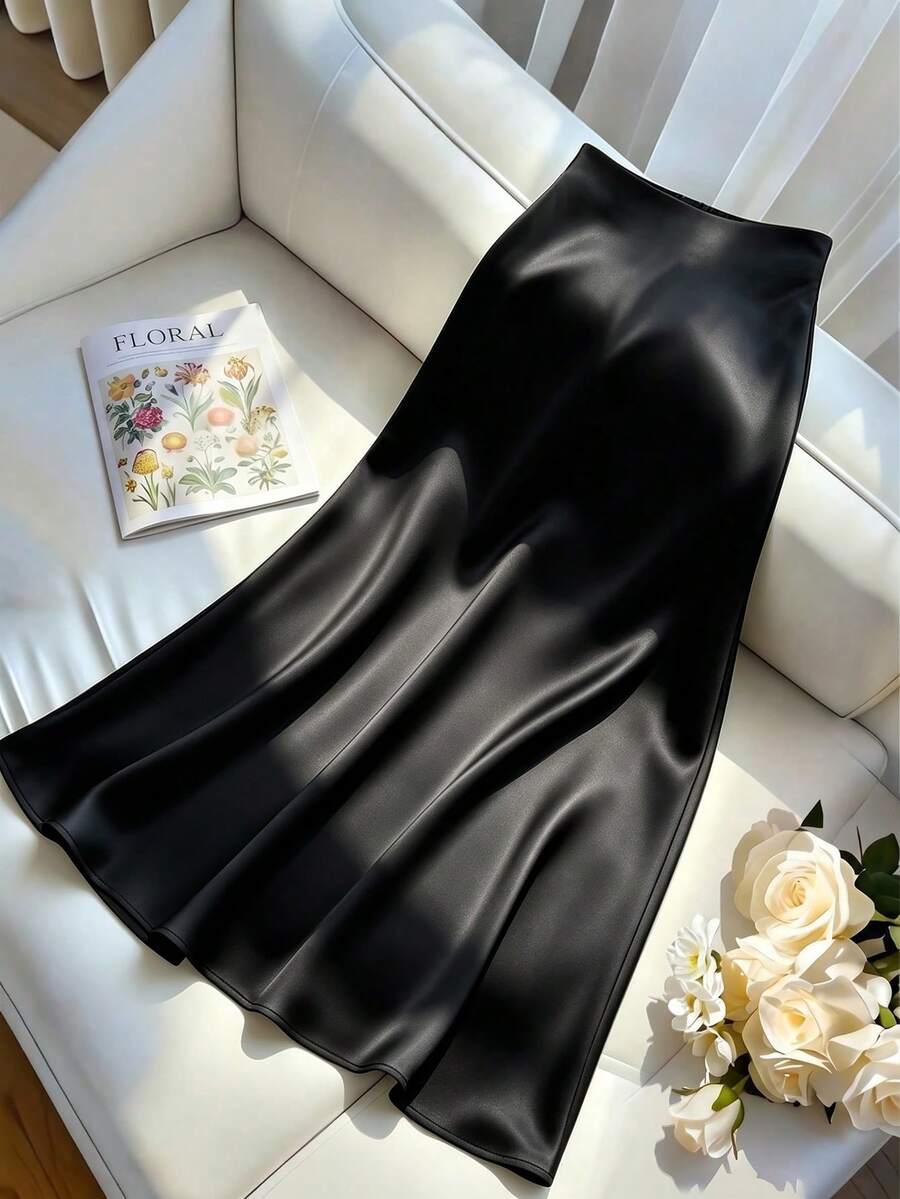 Women's elegant black A-line long skirt featuring a plain woven fabric, regular fit, natural mid-waist style, and flared hem design suitable for formal and evening wear.