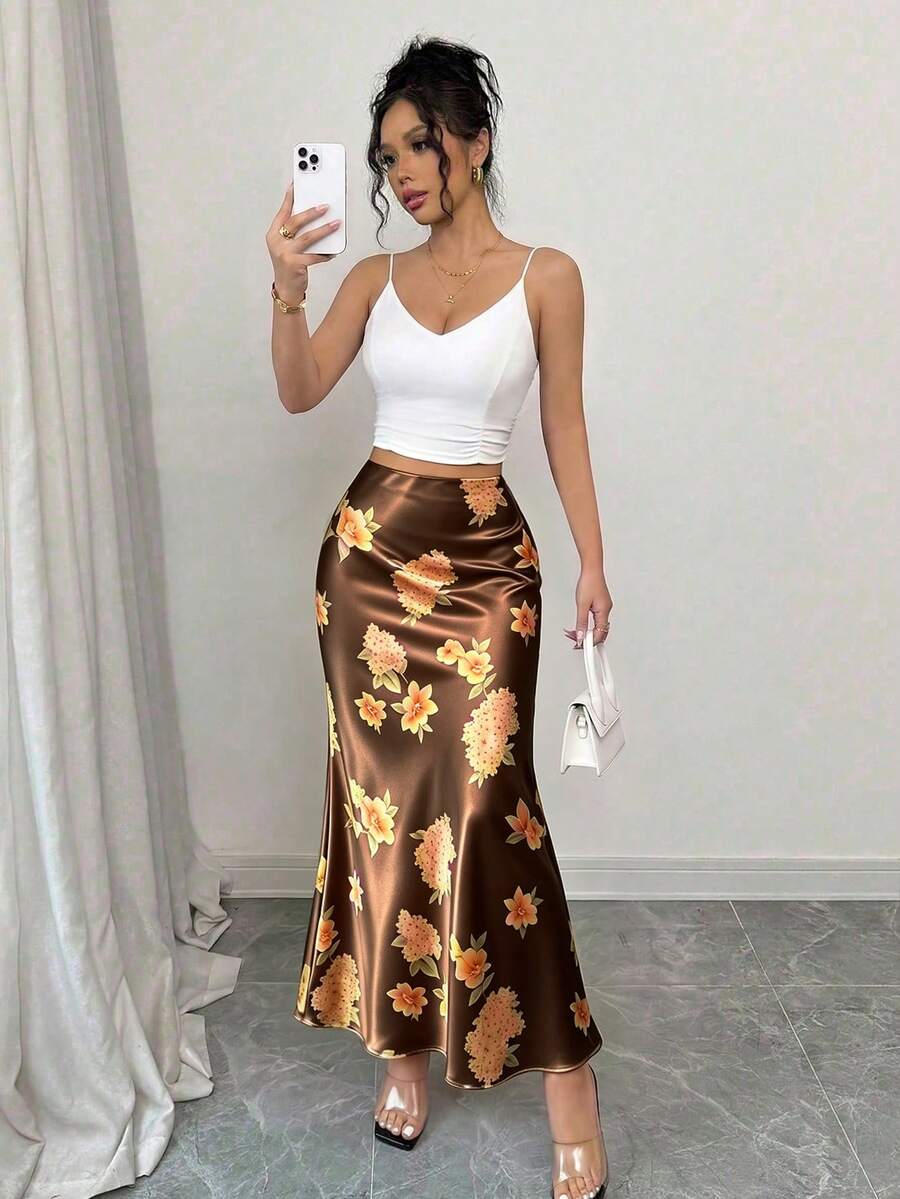 Women's elegant black A-line long skirt featuring a plain woven fabric, regular fit, natural mid-waist style, and flared hem design suitable for formal and evening wear.