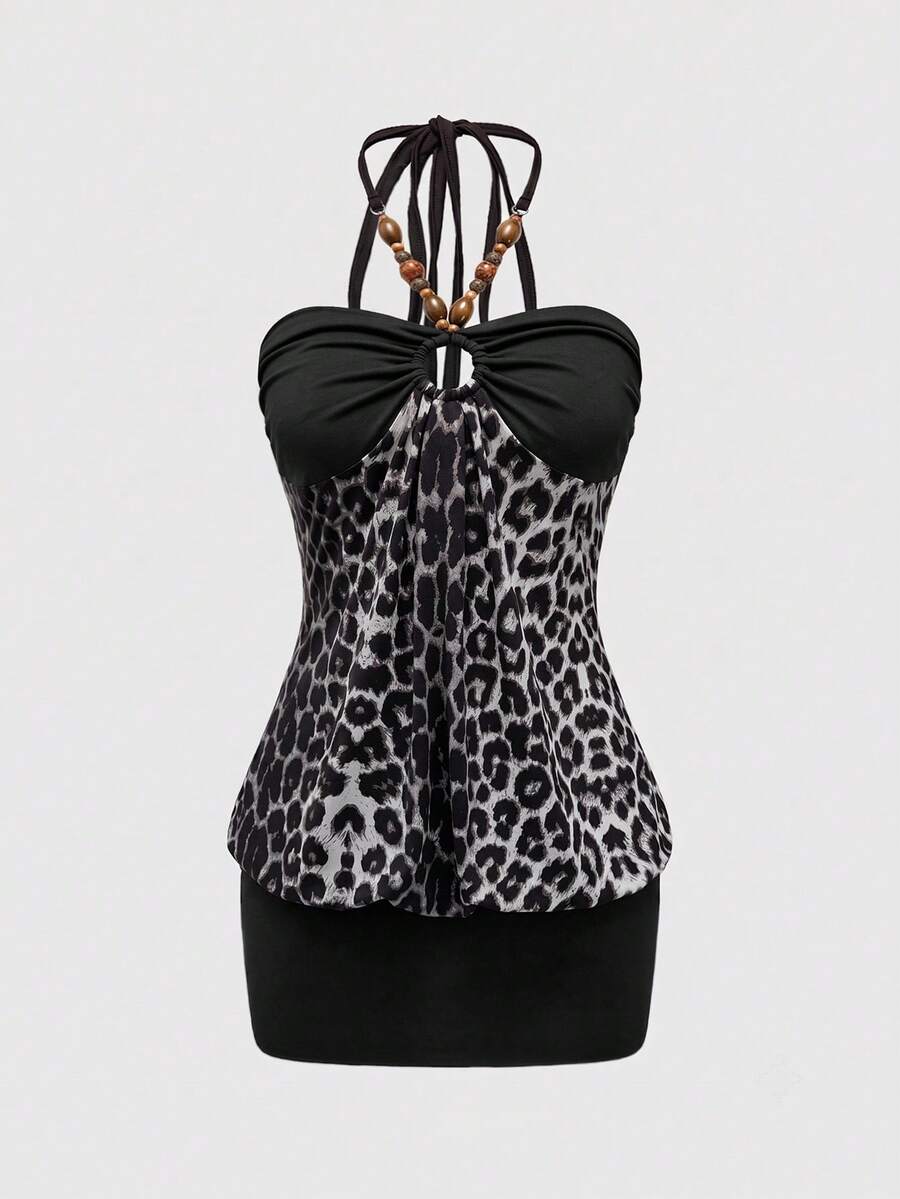 Women's black Y2K halter neck backless bodycon mini dress featuring beaded decor, textured patchwork pattern, natural waist, and slim fit pencil hem.