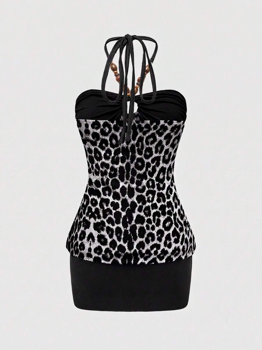 Women's black Y2K halter neck backless bodycon mini dress featuring beaded decor, textured patchwork pattern, natural waist, and slim fit pencil hem.