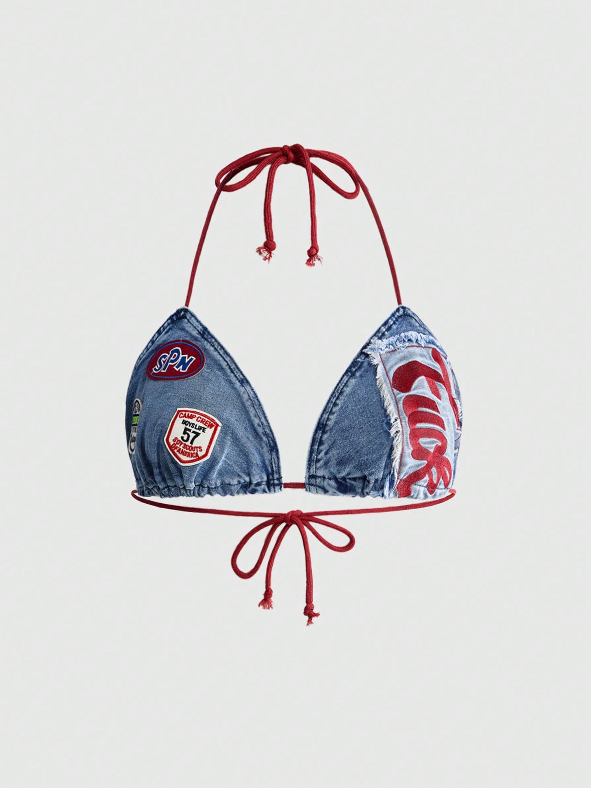 Blue denim sleeveless halter crop top for women featuring front knot tie detail and slim fit design.