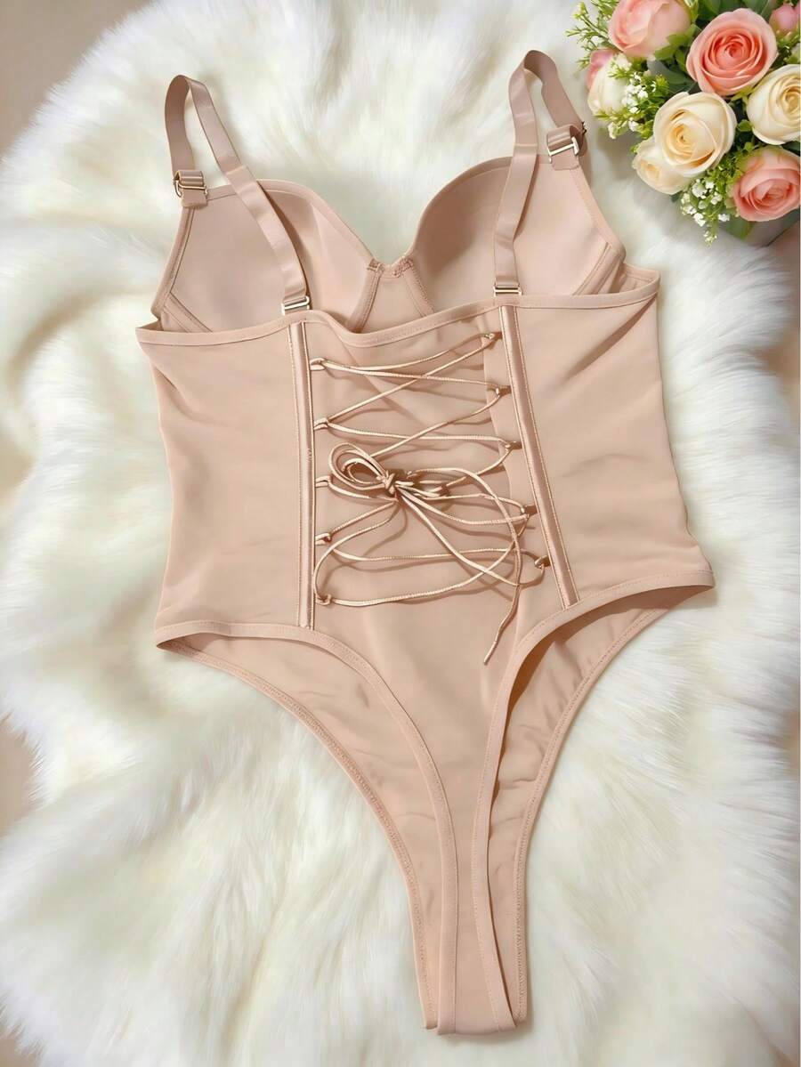Black shapewear bodysuit for women featuring a built-in push-up bra, back tie, zipper closure, and Bermuda shorts length.