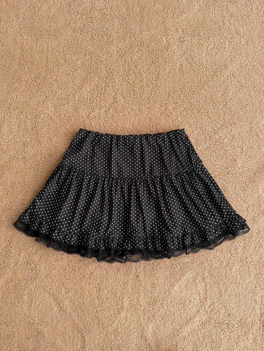 Women's plain black ultra low waist bodycon mini skirt with frill detailing in knitted stretch fabric.
