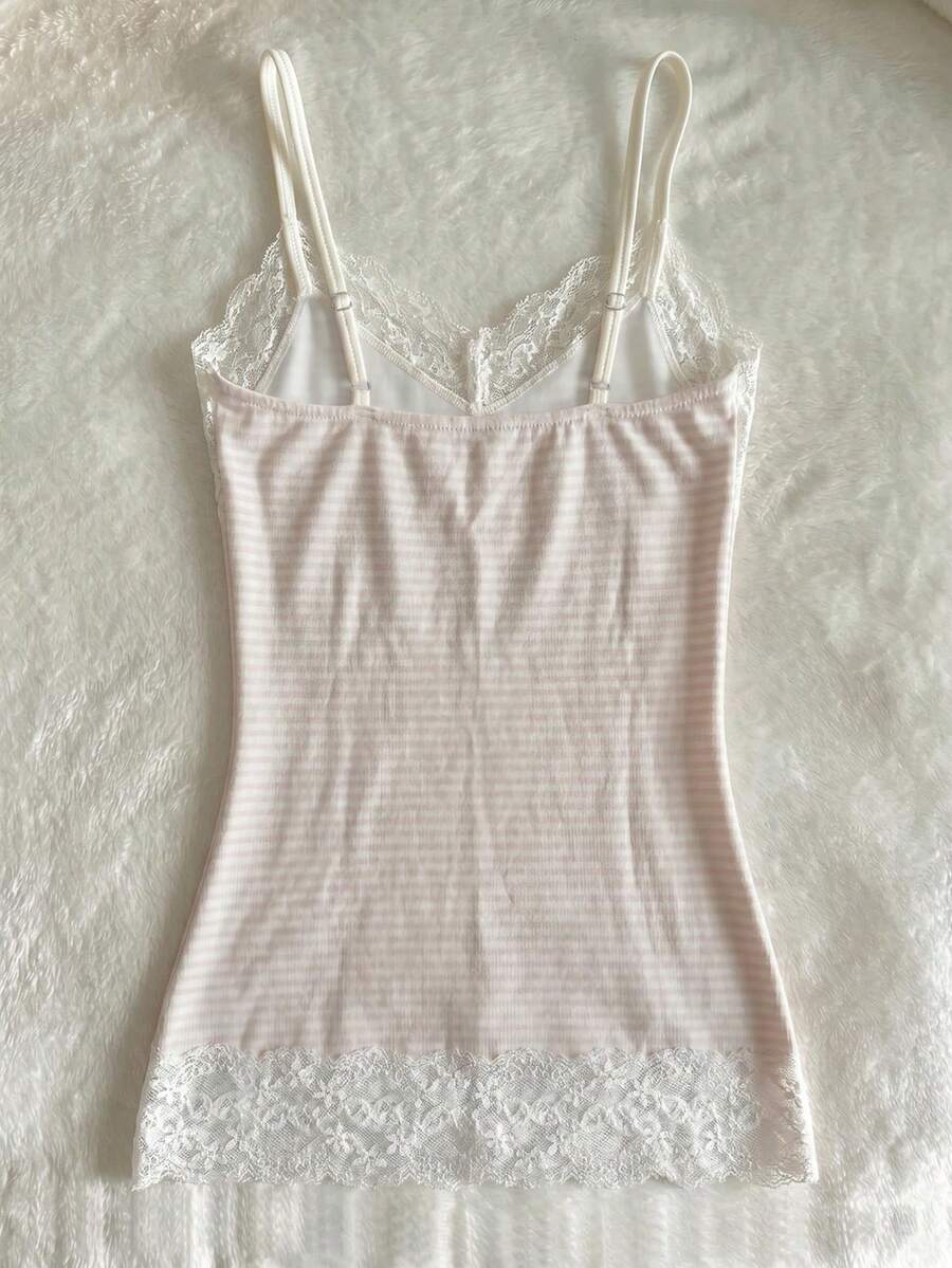 Women's solid color slim fit camisole top featuring delicate lace patchwork embroidery and tank straps.