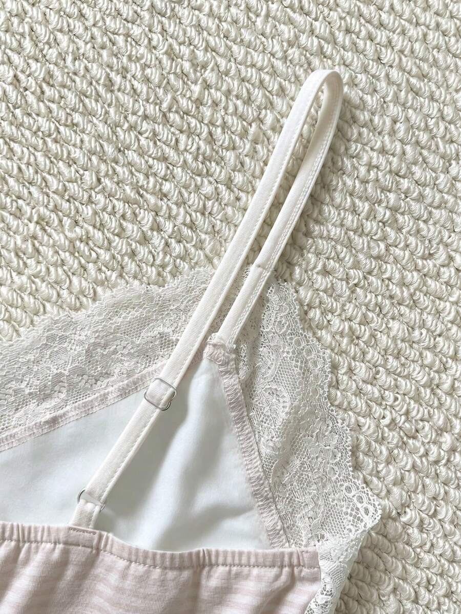 Women's solid color slim fit camisole top featuring delicate lace patchwork embroidery and tank straps.