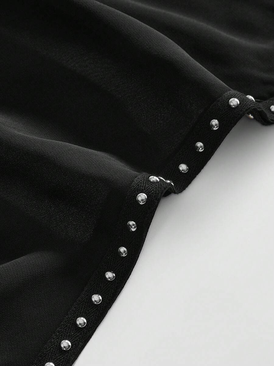 Women's black halter cowl backless crop top featuring asymmetrical draped hem and knot detail
