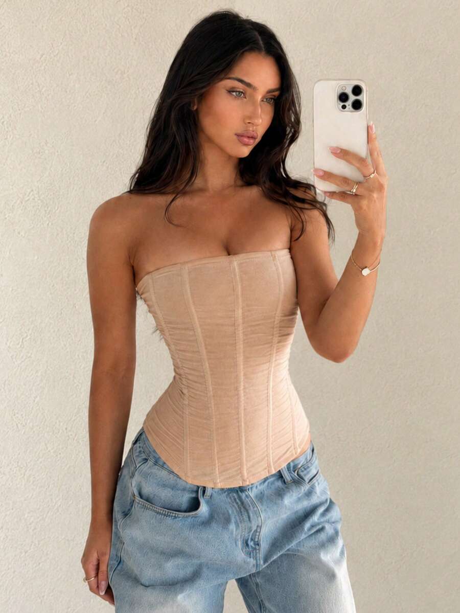 Black strapless mesh bustier top with a backless, semi-sheer design, slim fit, and crop length for women.