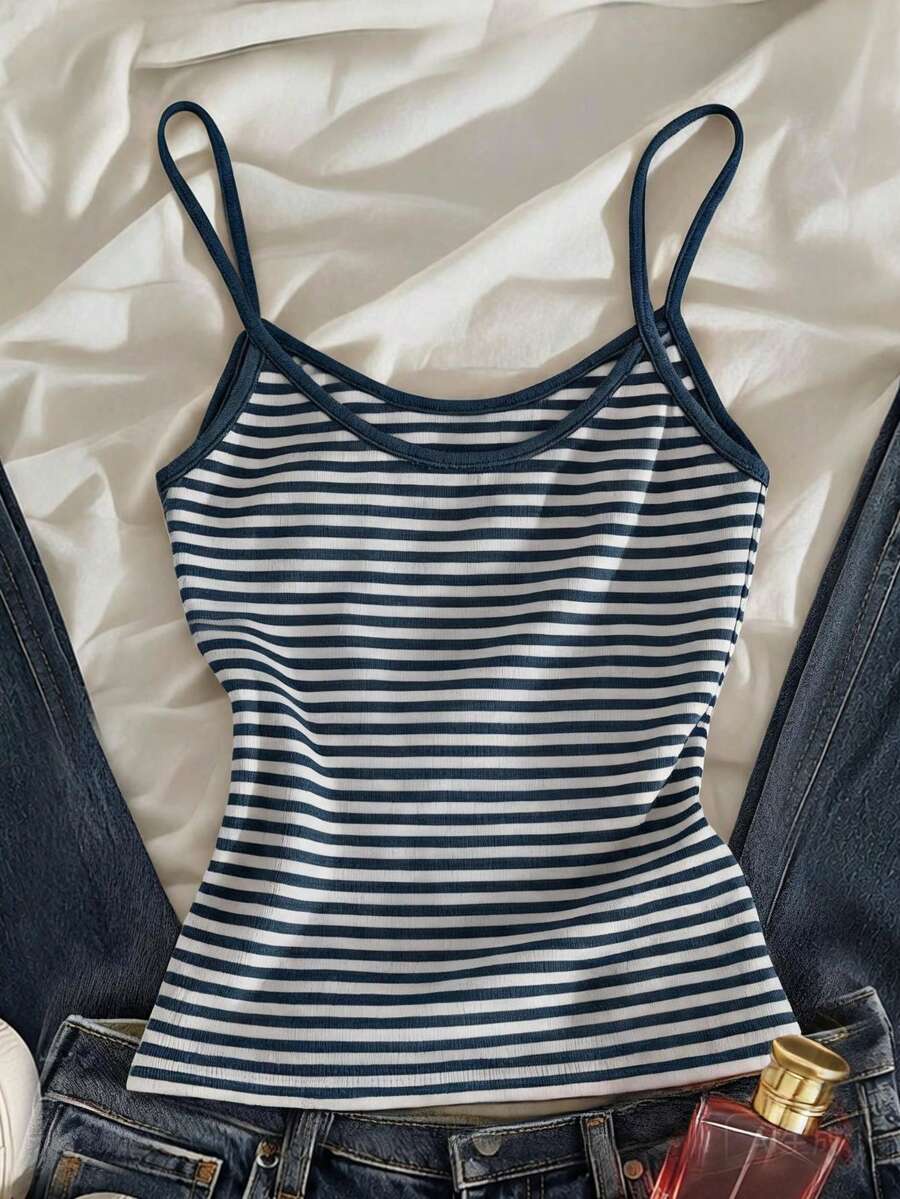 Women's pink striped crop camisole featuring criss cross spaghetti straps and slim fit design.