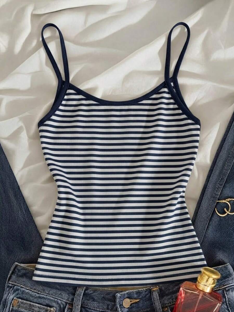Women's pink striped crop camisole featuring criss cross spaghetti straps and slim fit design.