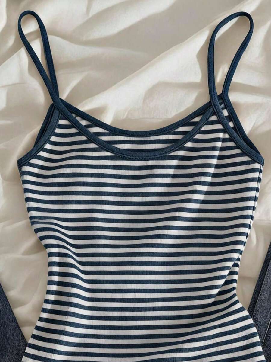 Women's pink striped crop camisole featuring criss cross spaghetti straps and slim fit design.
